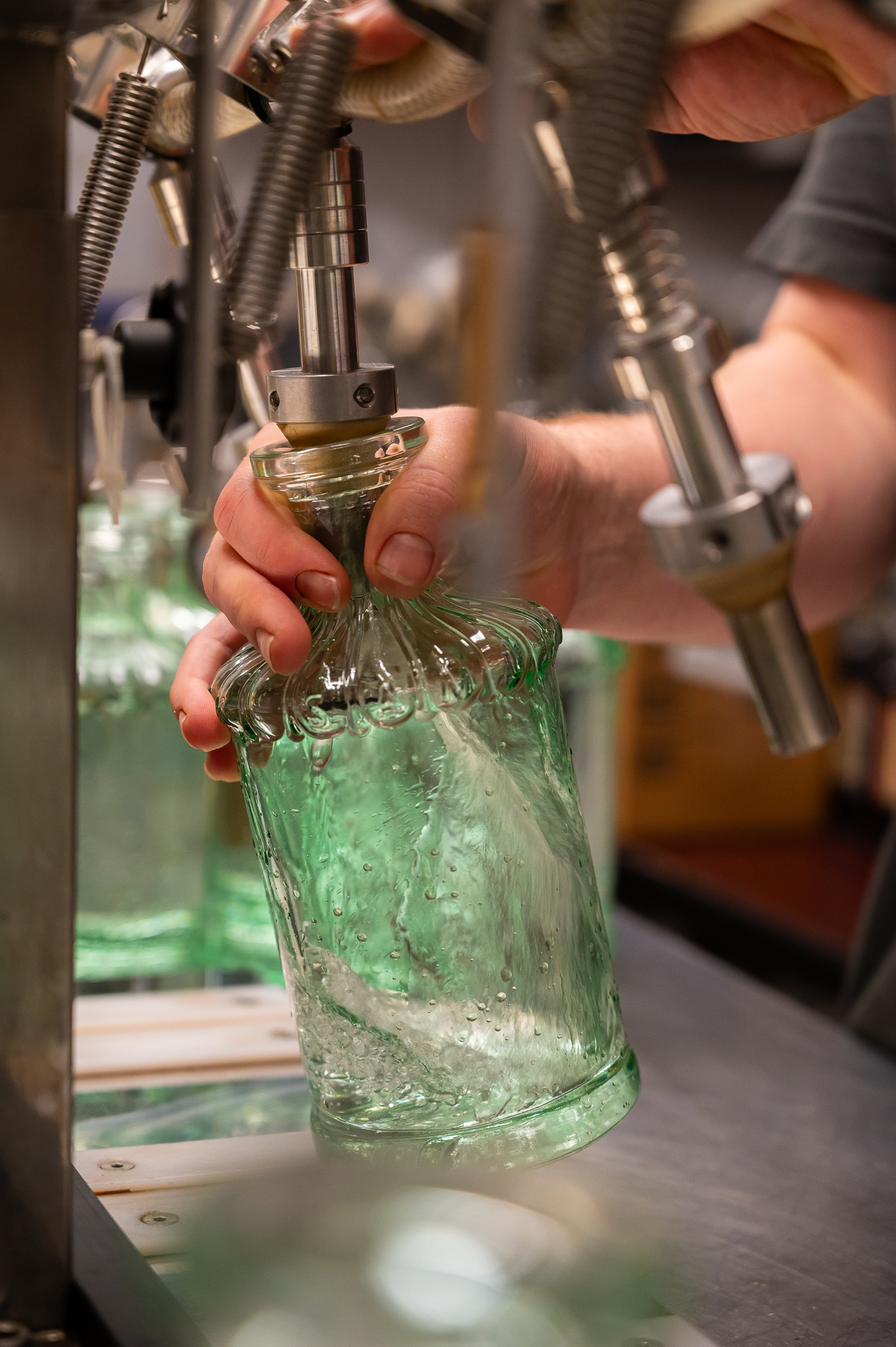 Bottling by hand at 115 Broadway